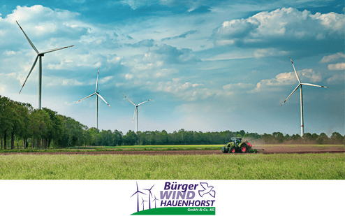 Landschaft mit Windr&auml;dern und einem Traktor, der auf einem Feld mit frischem Gr&uuml;n arbeitet, unter bew&ouml;lktem Himmel.